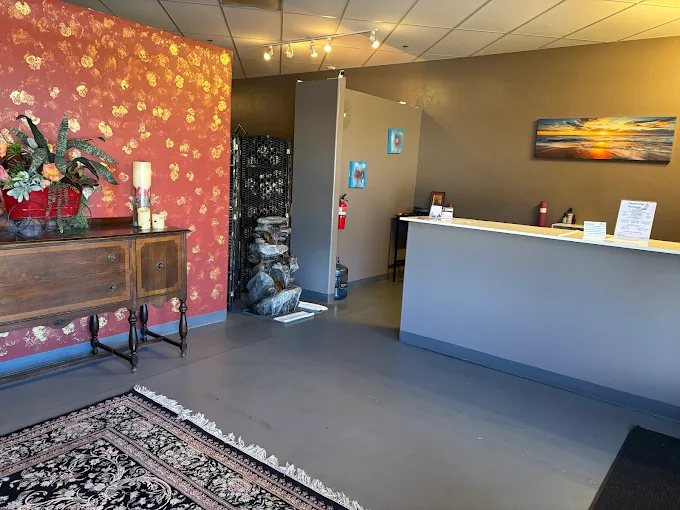 The Desert Zen front desk and lobby with a carved wooden sideboard and fresh flowers